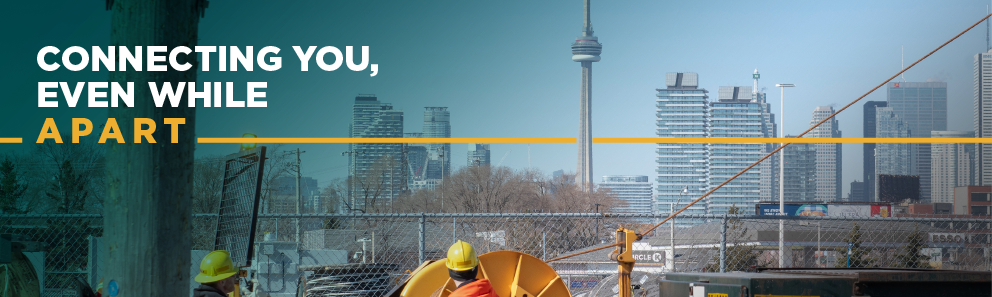 Banner image of two Toronto Hydro field workers against the backdrop of the Toronto skyline, with the tagline of 'Connecting you even while apart'