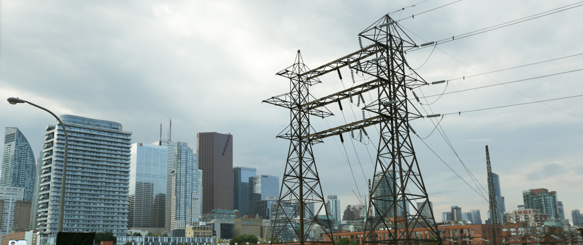 Transmission lines in Toronto (foreground) with high-rises in the background. 