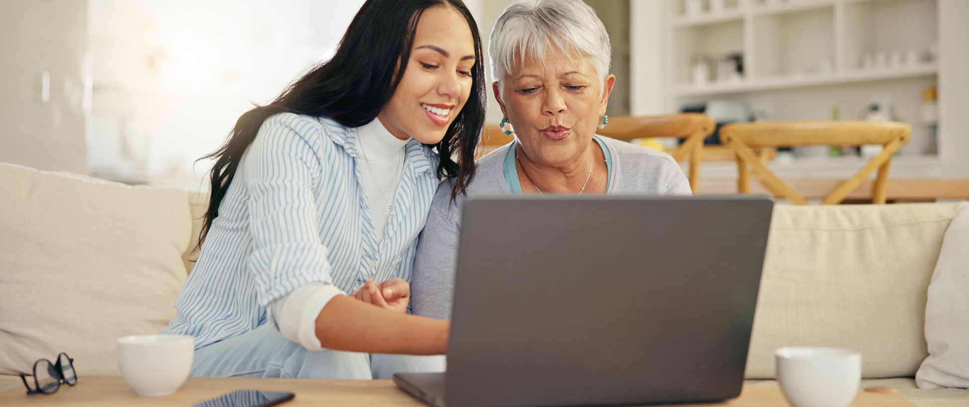 Customer Experience representative smiling with a headset and working at a desktop.